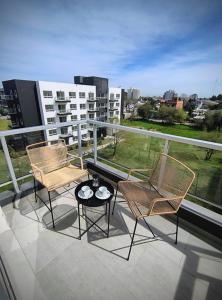 two chairs and a table on top of a balcony at Chill Aeropuerto Ezeiza 403 in Ezeiza