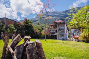 a fence in a yard with mountains in the background at Hostal Gocta in Cocachimba