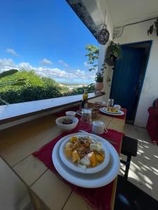 a plate of food on a table on a balcony at Quatro Ventos in Baía Formosa