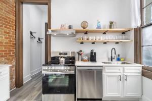a kitchen with a stove and a sink at Delightful Canal Street Family Home in Mid-City in New Orleans +14 photos