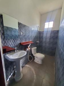 a bathroom with a sink and a toilet at Nionje Garden Villa in Jambiani