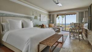 a bedroom with a large bed and a living room at Four Seasons Resort Nevis in Nevis +64 photos