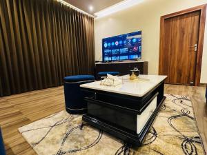 a room with a reception desk and a tv at Aruna Farm House in Kakarmatha