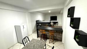 a small balcony with a table and chairs and a piano at Smart Loft Premium no Centro Moderno e Confortável in Presidente Prudente +28 photos