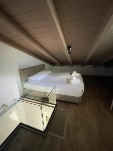 a bedroom with a bed and a glass table at Melodia Lefkada Maisonette 3 in Nikiana +11 photos