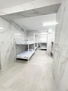 a room with two bunk beds in a room with marble walls at Hostel Almansa in Madrid