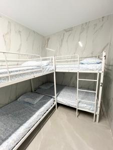 two bunk beds in a room with marble walls at Hostel Almansa in Madrid