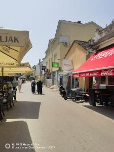 a city street with tables and chairs and buildings at Hostel Centrum in Mostar +11 photos