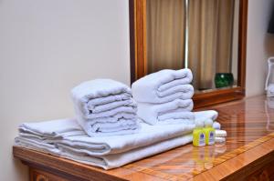 a pile of towels on a table in front of a mirror at Karvan-N in Toshkent-Passajir Bekati +94 photos