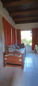 a bed in a room with red curtains at Casa Cerca del Mar, cinco personas in Ostende +10 photos