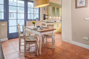 a kitchen with a table and chairs in a room at Ferienhaus "Kleine Auszeit" in Zingst in Zingst