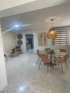 a living room with a dining table and chairs at Hostal FT Santiago Stay in Santiago de los Caballeros