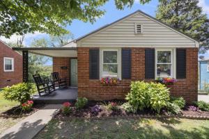 a brick house with flowers in the front yard at 3BR Cottage Near Downtown Kingsport in Kingsport