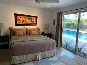 a bedroom with a bed and a sliding glass door at USS San Lorenzo in Palm Springs +32 photos