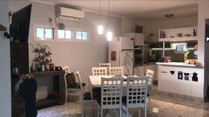 a kitchen and dining room with a table and chairs at Casa SIÓN in Ituzaingó