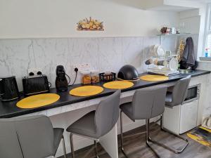 a kitchen with a counter with yellow plates on it at The Yellow Door in Birr