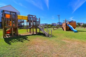 a playground with a slide in a field at 7144 - Dolphin Lookout ( formerly Sabah Vacations) in Wanchese