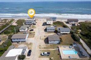 an aerial view of a house with a beach and a balloon at 7144 - Dolphin Lookout ( formerly Sabah Vacations) in Wanchese
