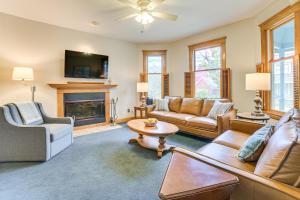 a living room with a couch and a fireplace at Steps to Dtwn and River! Boyne City Family Retreat in Boyne City