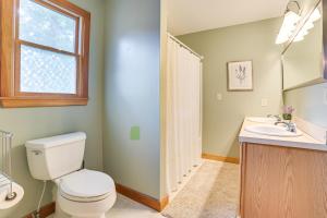 a bathroom with a toilet and a sink at Steps to Dtwn and River! Boyne City Family Retreat in Boyne City +17 photos