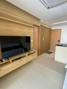 a living room with a large flat screen tv at Modern Condo Doca in Umarizal in Belém