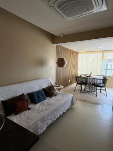 a bedroom with a bed and a dining room at Modern Condo Doca in Umarizal in Belém