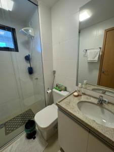 a bathroom with a toilet and a sink and a shower at Modern Condo Doca in Umarizal in Belém +9 photos
