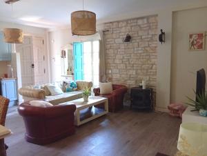 a living room with couches and a stone wall at Caminito del Rey Carratraca in Sierra Las Aguas in Malaga