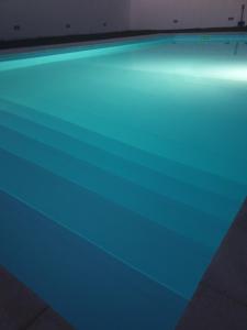 a swimming pool with blue lights on top of it at Casa do Outeiro - AL in Praia da Vitória