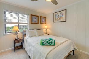 a bedroom with a bed and a lamp and a window at Steps to Sand! Condo with 2 Pools in Atlantic Beach in Atlantic Beach +17 photos