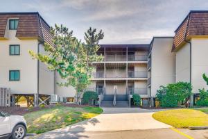 an apartment building with a car parked in front of it at Steps to Sand! Condo with 2 Pools in Atlantic Beach in Atlantic Beach