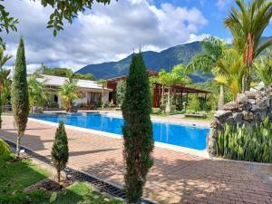 a resort with a swimming pool and mountains in the background at La Quinta de Andrés in San Isidro +81 photos