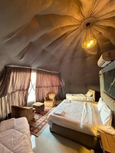 a bedroom with a bed in a tent at Nala Luxury Camp & Jeep Tours in Wadi Rum
