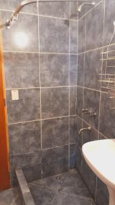 a bathroom with a shower and a sink at Departamento turístico SMA in San Martín de los Andes