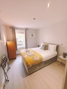 a bedroom with a large bed and a window at Central City Apartment - Free Parking in Belfast