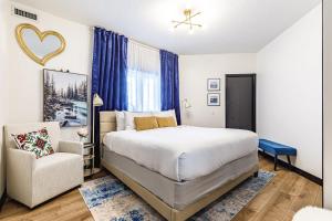 a bedroom with a bed and a chair at Westwinds - Funky Basecamp in the Rockies in Canmore +77 photos