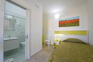 a bedroom with a bed and a bathroom with a sink at Podere San Luigi Residence in Otranto +81 photos