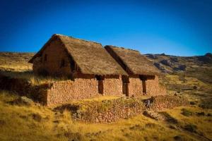 an old stone building on the side of a hill at HOTEL HUAYTARA CasaBlanca in Huaytará