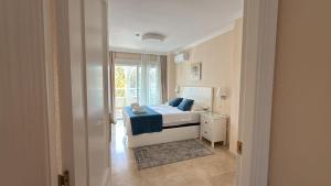 a bedroom with a bed and a window at Playa Albir Apartments in Albir +37 photos