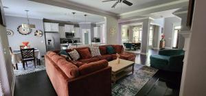 a living room with a couch and a dining room at SASA Deer Lodge Superb 6-bedroom house with AC in Richmond Hill