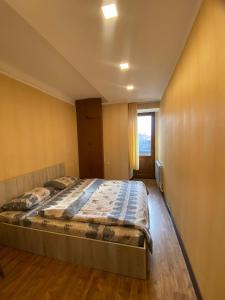 a large bed in a room with a window at Family Apartment in Yerevan +4 photos