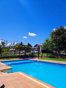 a swimming pool with blue water in a yard at San Rafael del Campo - Barichara in Barichara