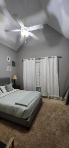 a bedroom with a bed and a ceiling fan at SASA Deer Lodge Superb 6-bedroom house with AC in Richmond Hill