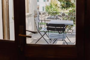 a table and a chair sitting on a balcony at Antico Villino - Elegant Accommodation with Parking in Conegliano +42 photos