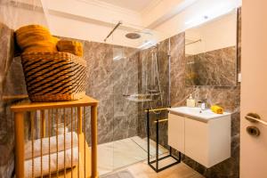a bathroom with a shower and a sink at Villa Crossdeira - A Wellness Retreat in Arco da Calheta +22 photos