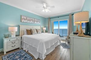 a bedroom with a bed and a large window at Crystal Shores West Unit 705 in Gulf Shores
