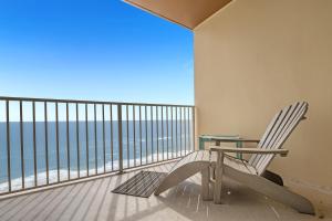 a balcony with a chair and a table and the ocean at Crystal Shores West Unit 705 in Gulf Shores