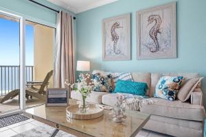 a living room with a couch and a table at Crystal Shores West Unit 705 in Gulf Shores