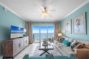 a living room with a flat screen tv and a couch at Crystal Shores West Unit 705 in Gulf Shores +42 photos