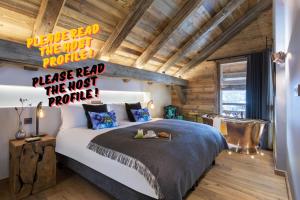 a bedroom with a bed in a room with wooden ceilings at Luxuryy Chalet - Megeve - with Pool&HotTub in Megève